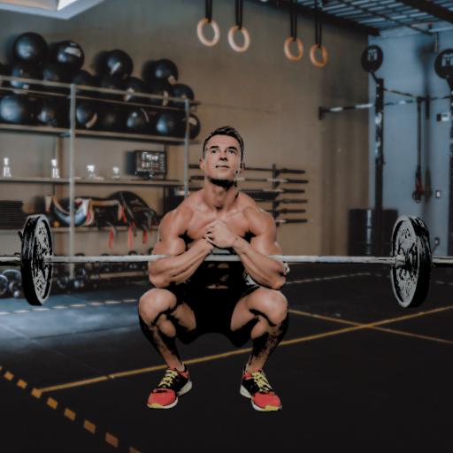 A man in a gym doing a variation of the squat called a Zercher squat.