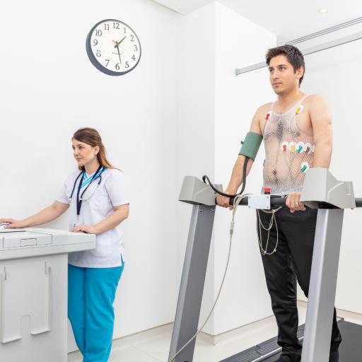 man on treadmill with female researcher monitoring