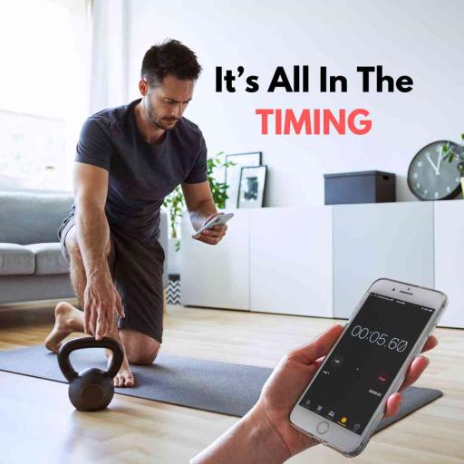 A man resting after an exercise while looking at a timer on his phone.